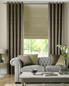 Roman blind layered with long curtains at a sitting-room window