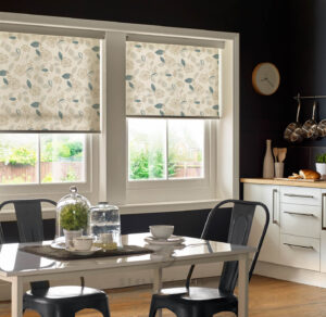Patterned roller blinds above a dining table in a real domestic kitchen